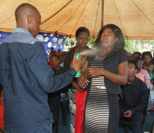 Church Pastor spraying pesticides to its worshipers