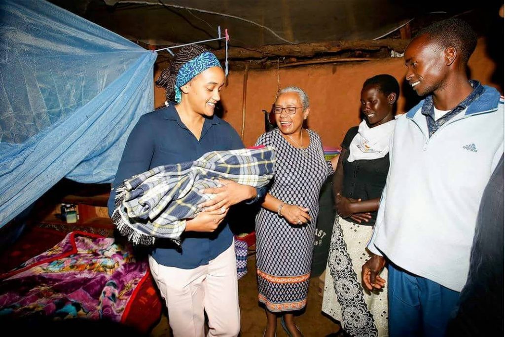 First lady and First daughter Ngina Kenyatta preparing holding baby